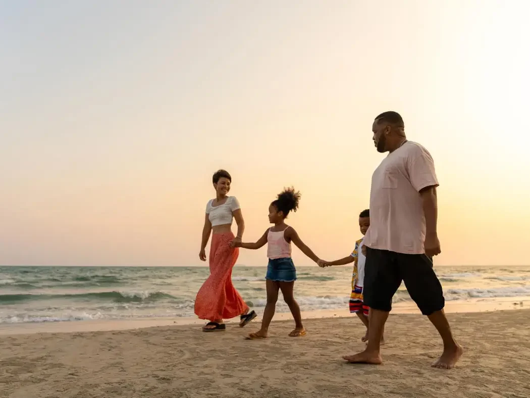 African Caribbean Community family walk on the beach