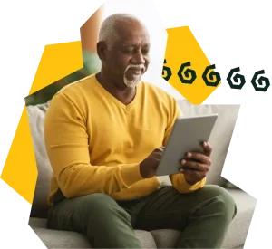 Mature man from African Caribbean community sitting whilst viewing his HEAL-D course on a digital tablet.